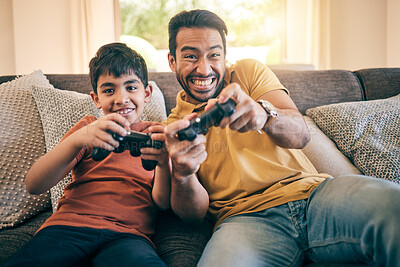 Buy stock photo Family, fun and a boy gaming with his father on a sofa in the living room of their home together for competition. Video game, children and a man learning how to play from his gamer son in the house