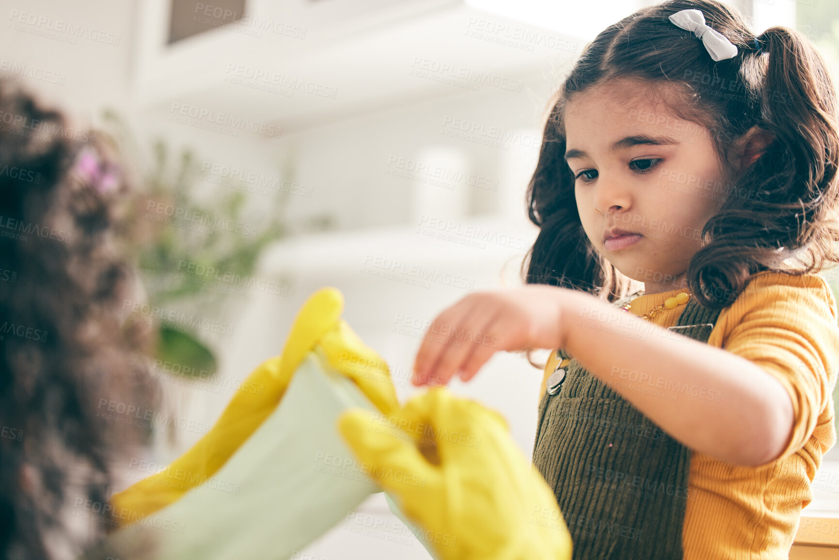 Buy stock photo Girl, mom and kitchen to put rubber gloves on hands, helping and show skills in family home. Spring cleaning, mother and daughter by ppe, hygiene and teaching for safety, bacteria and dirt in house