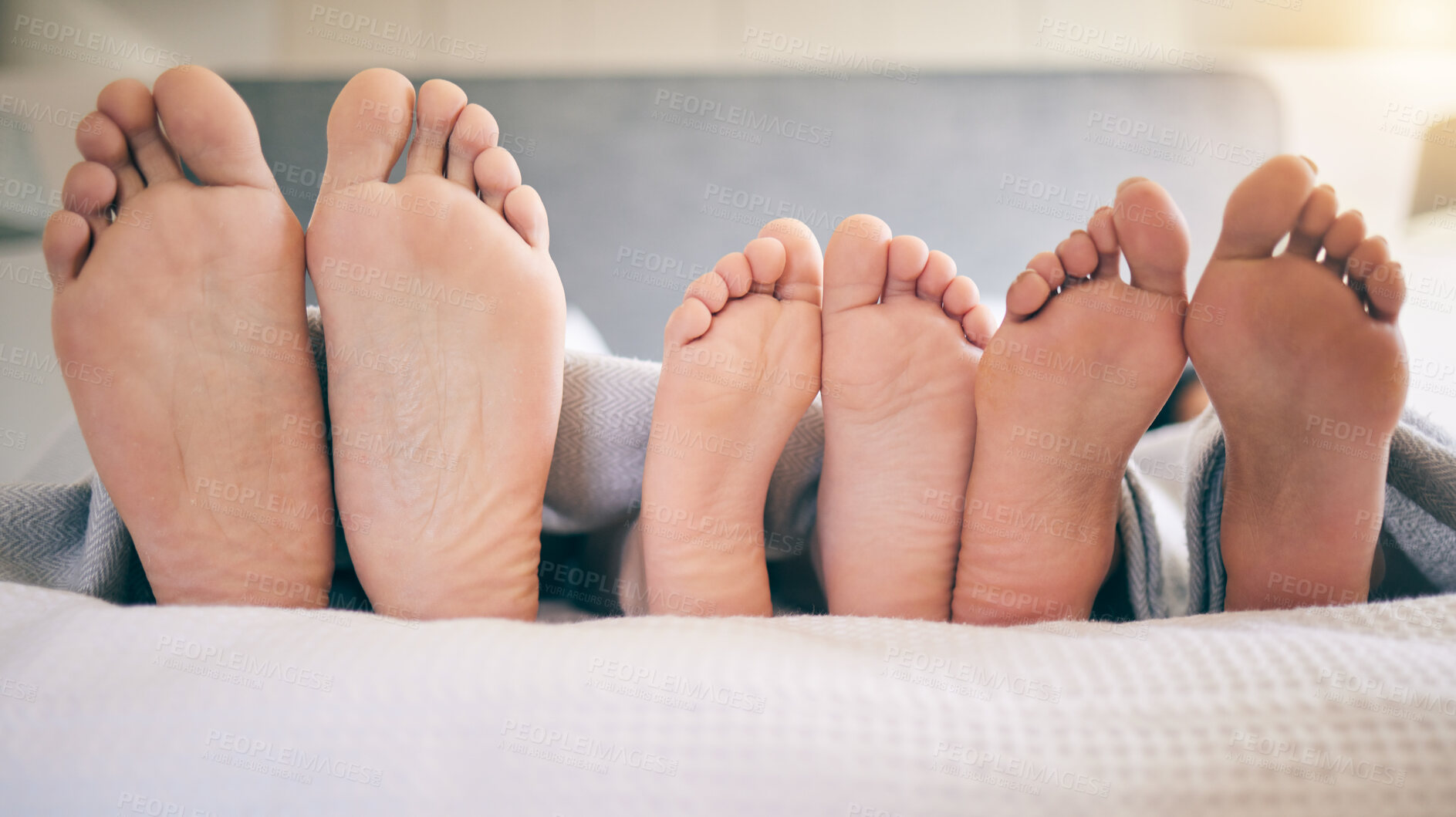 Buy stock photo Family feet, bed and closeup with kid to relax with love, rest and sleeping on hotel mattress for vacation. Parents, sleep and bedroom with child, mom and father for bonding, care and safe in house