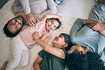 Happy family, bed and playing in bonding, weekend or day off in relax together above at home. Top view of father, mother and children smile in joy or laughing for fun childhood or morning in bedroom