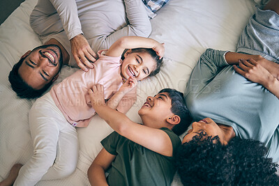 Buy stock photo Happy family, bed and playing in bonding, weekend or day off in relax together above at home. Top view of father, mother and children smile in joy or laughing for fun parents or morning in bedroom