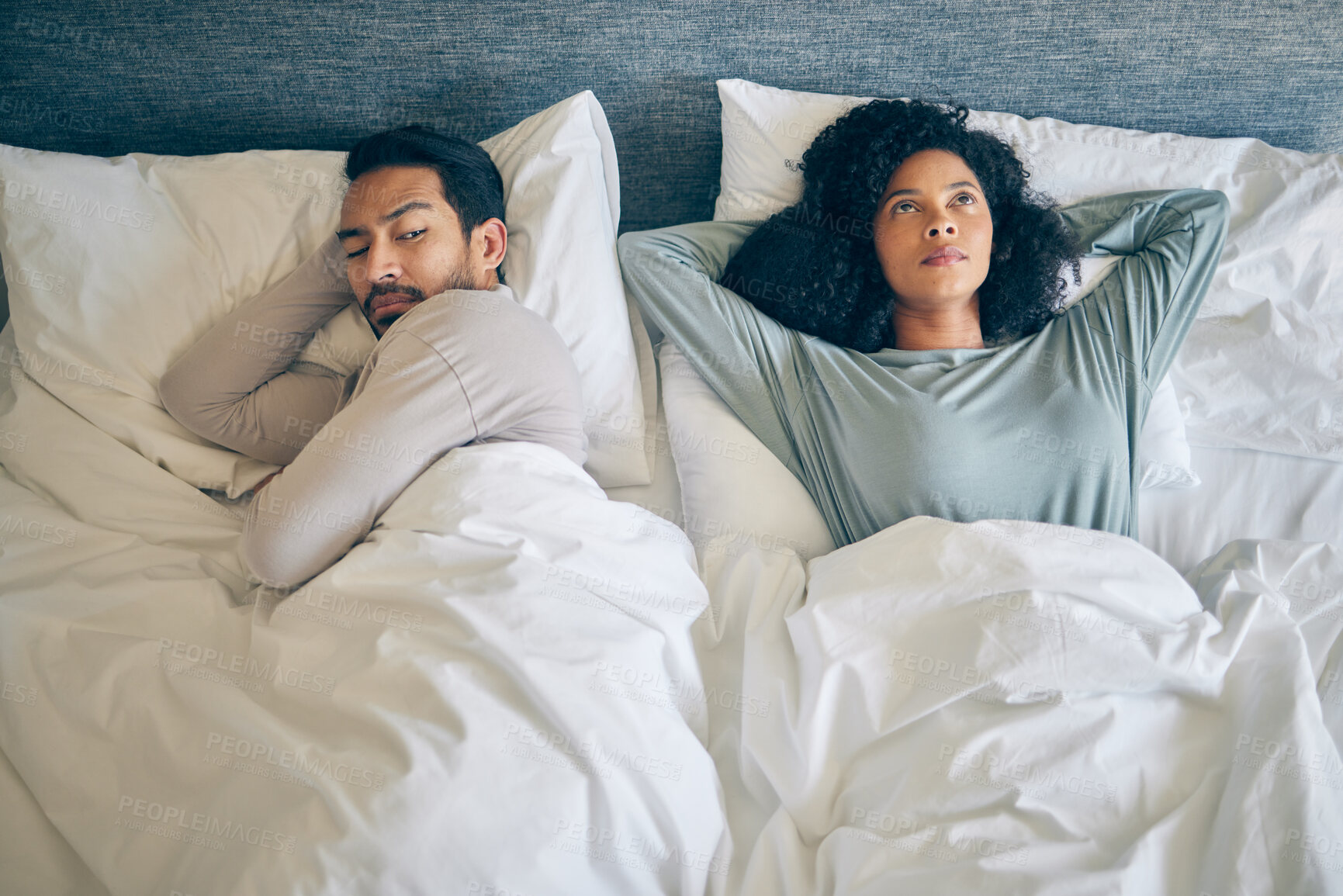 Buy stock photo Interracial couple, fight and stress in bedroom for divorce, anger and thinking of breakup, cheating and anxiety from above. Man, woman and partner in bed for conflict, argument and drama of dispute 