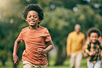 Portrait, running and children at a park with parents, freedom and playing in nature together. Love, energy and excited kid face run in a forest with mother, father and bonding, smile and race games