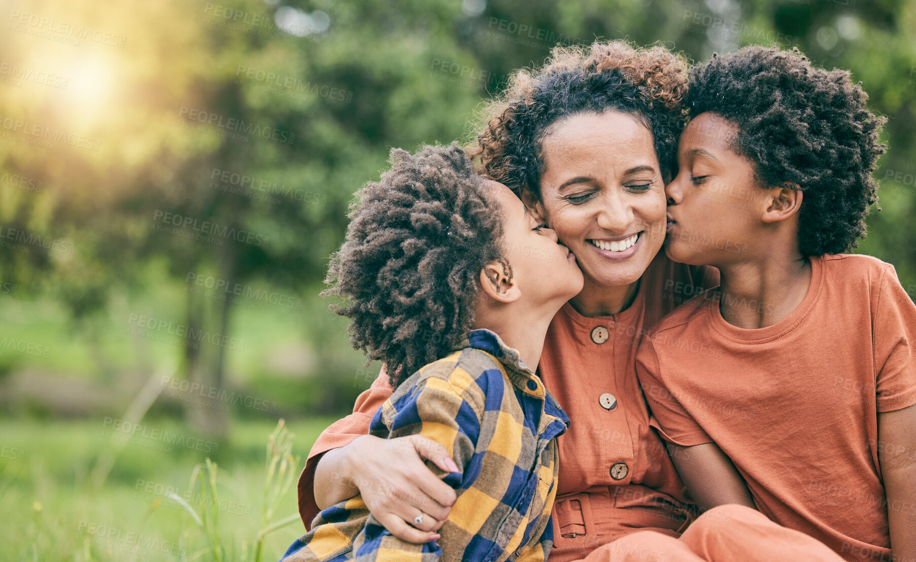 Buy stock photo Happy, kiss and mother with children in park for relax, bonding and love mockup. Care, support and smile with woman and kids in grass field in nature for black family, summer and happiness together