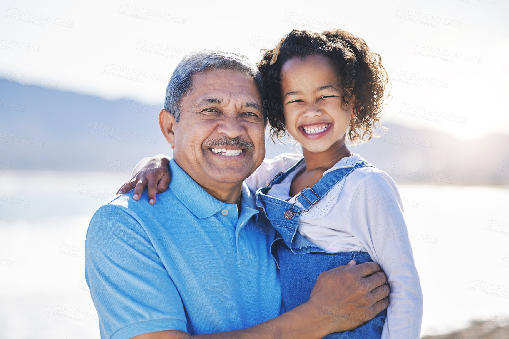 Buy stock photo Happy, beach and portrait of child with grandfather on a vacation as travel together on outdoor holiday for happiness. Hug, smile and grandparent with kid or grandchild by ocean or sea for adventure