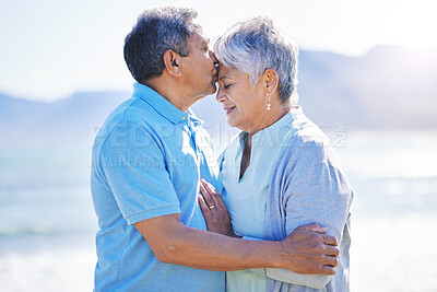 Buy stock photo Kiss, love and senior couple at a beach for travel, bond and happy in nature together. Romance, kissing and elderly man embrace old woman at sea, trust or security on traveling ocean trip in Mexico