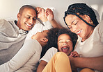 Family, bed and laughing in morning in happy home while playing, tickle or bonding with love. African woman, man and kids lying in bedroom for security, wake up and relax with funny mother and father