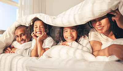 Buy stock photo Happy family, bed and under blanket in home bedroom while comfortable, portrait and together. African woman, man and kids lying with cover for security, wake up and relax with mother and father