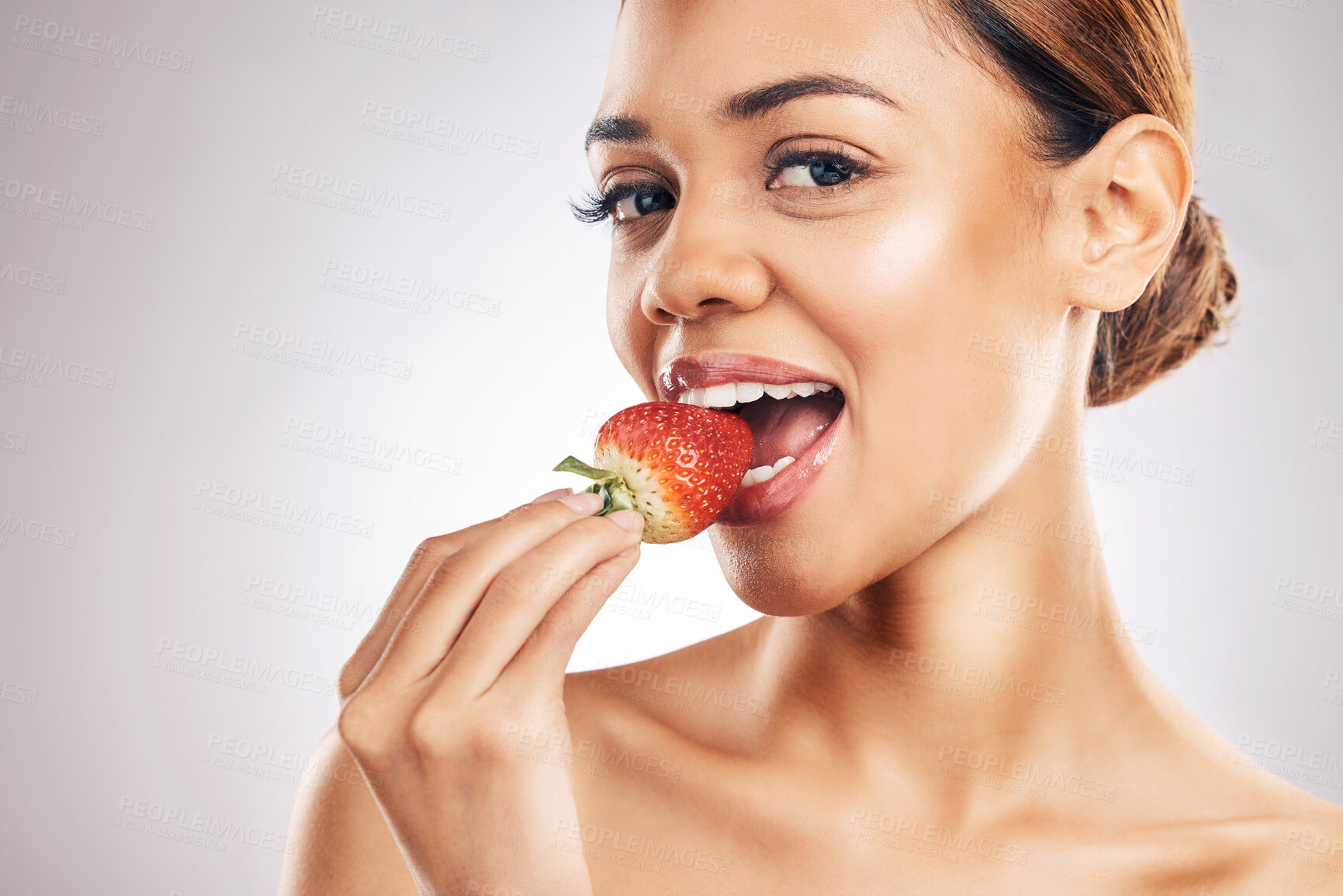 Buy stock photo Woman, eating strawberry and skincare portrait, beauty or eco friendly product and natural cosmetics in studio. Happy person, face and red fruit for vegan makeup or dermatology on a white background