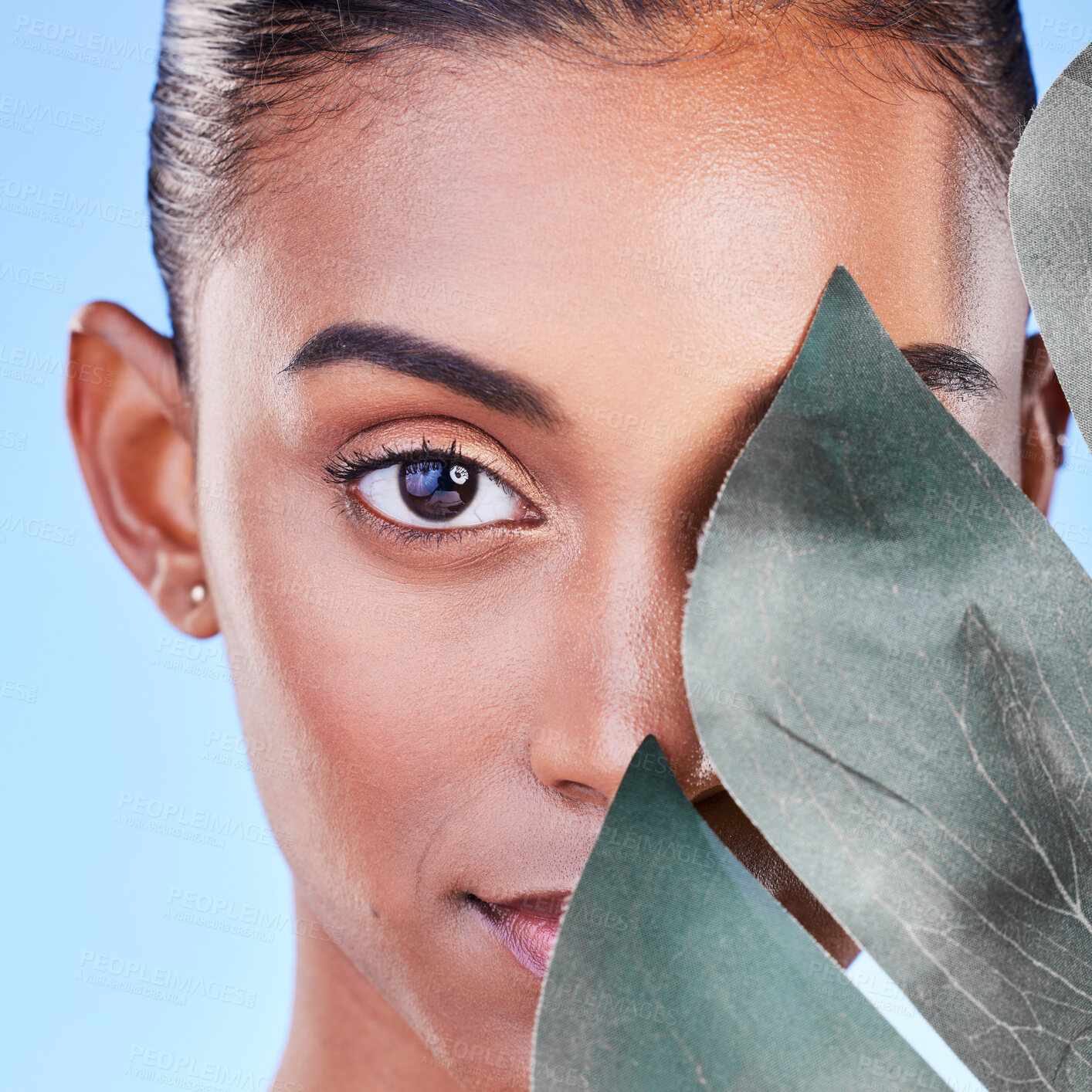 Buy stock photo Leaf, beauty and portrait of woman in studio for eco friendly, wellness or cosmetics on blue background. Monstera, face and lady with natural dermatology, skincare or organic, results or satisfaction