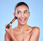 Beauty, face and woman with makeup brush in studio for powder, cosmetic or application on blue background. Foundation, skincare and lady model with cheek tools for contour, cover or facial treatment