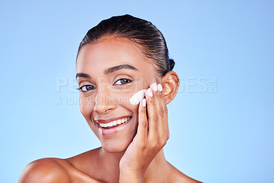 Buy stock photo Skincare, cream and moisturizer with portrait of woman in studio for beauty, facial or product. Spa treatment, lotion and collagen with face of person on blue background for makeup, glow or sunscreen