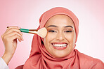 Makeup, brush and muslim woman portrait with a smile from cosmetics and blush in studio. Facial, glow and happy female person with beauty, skincare and shine with a hijab and skin tool for face