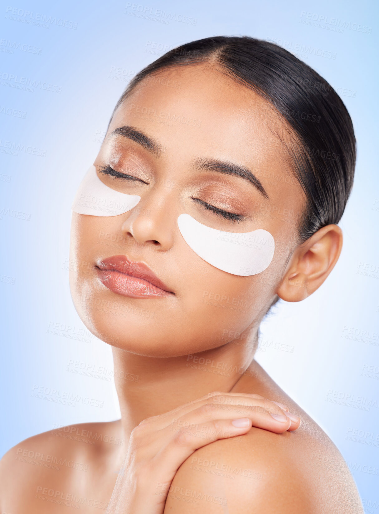 Buy stock photo Skincare, beauty and woman with eye patch for anti aging or skin glow on blue background. Cosmetics, facial detox and face of model with luxury mask or collagen product for dermatology pad in studio.