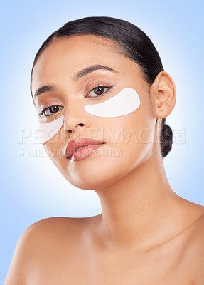 Buy stock photo Eye patch, woman and portrait for skincare and face health, dermatology and self care shine in studio on blue background. Beauty, person and facial product with collagen mask, wellness and glow 