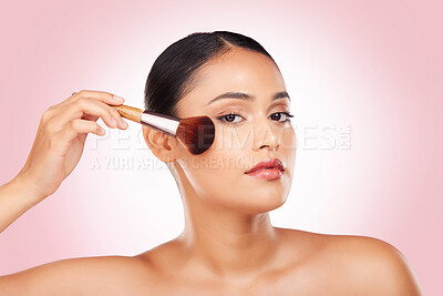 Buy stock photo Cosmetics, makeup brush and portrait of woman in studio for glamour, glow or face routine. Beauty, self care and young Indian female model with facial cosmetology product isolated by pink background.