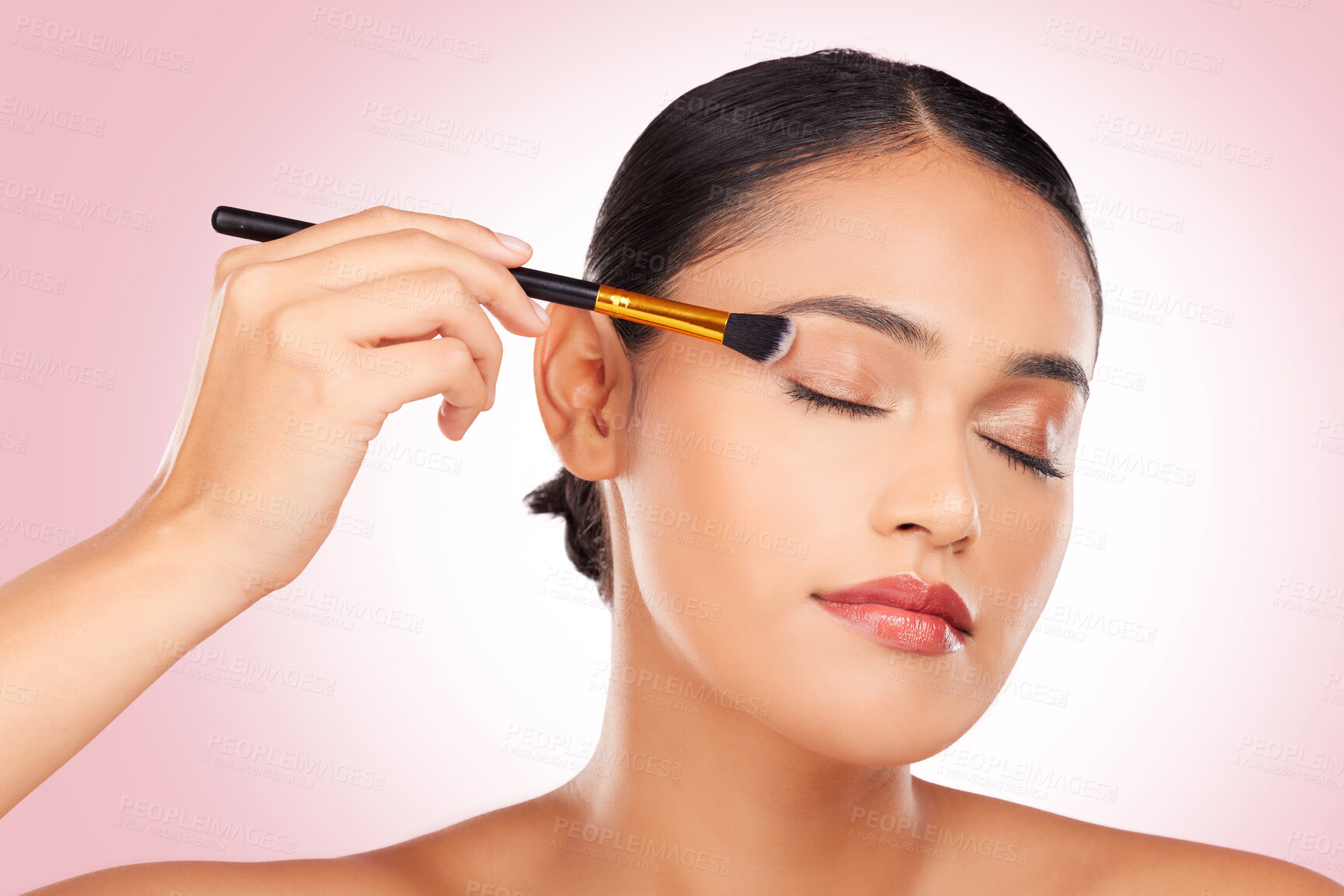 Buy stock photo Woman, makeup and eye brush in studio for beauty, skincare or face application on pink background. Young model, dermatology and cosmetics tools for eyeshadow glow, facial powder or aesthetic makeover