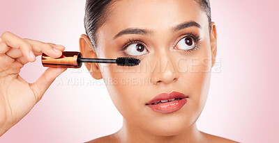 Buy stock photo Beauty, woman and mascara for makeup and skincare, cosmetics and application in studio on pink background. Self care, person and brush for eyelash extension, product and aesthetic for volume