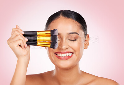 Buy stock photo Face makeup, beauty brush and happy woman with cosmetics tools, skincare wellness and facial transformation. Foundation application product, eyes closed and aesthetic studio person on pink background