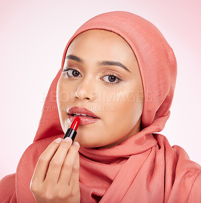 Buy stock photo Portrait, beauty or lipstick with an arab woman closeup in studio on a pink background for cosmetics. Face, makeup and muslim with a confident young model in an hijab to apply a product for red color