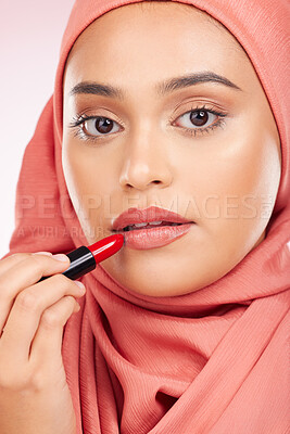 Buy stock photo Portrait, beauty and makeup with a muslim woman closeup in studio on a pink background for cosmetics. Face, lipstick and islamic with a young model in an hijab to apply a product for red color