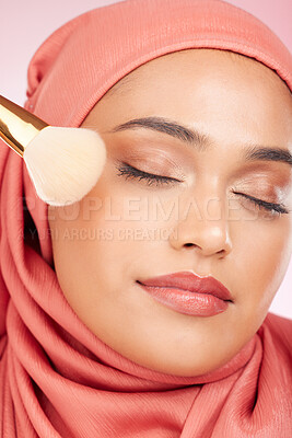 Buy stock photo Makeup brush, relax and muslim woman closeup with a smile from cosmetics and blush in studio. Facial, glow and happy female person with beauty, skincare and shine with a hijab and skin tool for face