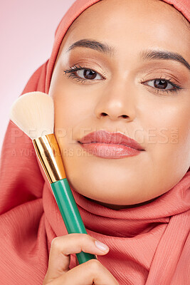 Buy stock photo Cosmetics, brush and portrait of Islamic woman with makeup artist tools, beauty product and self care glow. Facial powder application, studio and hijab face of Arabic Muslim model on pink background