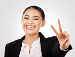 Happy business woman, portrait and peace sign in career ambition or positive mindset against a studio background. Face of female person or employee smile in happiness with emoji or hand gesture