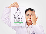 Portrait, smile and eye test with a woman optician in studio on a gray background for vision or eyesight. Face, medical and a happy young doctor in a clinic or optometry office for a visual exam