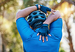 Man, cyclist and stretching arms in nature in sports fitness, workout or outdoor exercise for wellness. Active male person, back or athlete in warm up, cycling or ready for training or adventure