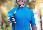 Man, cyclist and handshake in fitness, partnership or deal in agreement, greeting or competition in nature. Closeup of male person athlete shaking hands for introduction, workout or outdoor exercise