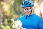 Winner, trophy or happy man cyclist in celebration of victory performance or success in a race tournament. Award, motivation or proud sports athlete winning a cycling competition with smile or reward