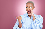 Pointing, secret and a woman in studio for surprise advertising, marketing or announcement. Happy face of an excited African person on a pink background with hand for choice, gossip or mockup space