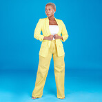 Corporate, business woman and entrepreneur in studio assertive for career, job and startup on blue background. Professional, fashion and creative young person with confidence, pride and ambition 