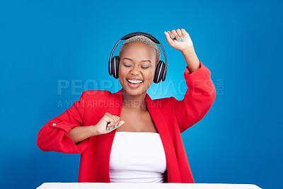 Buy stock photo Music, dance and black woman with headphones in studio celebration with news, feedback or promo on blue background. Freedom, happy and African lady dancing to earphones radio, podcast or streaming