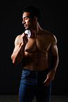 Sexy, muscle and topless man in studio with fitness inspiration, beauty aesthetic and sensual fashion. Erotic art, sexual body and male model sitting on black background, thinking in dark lighting.