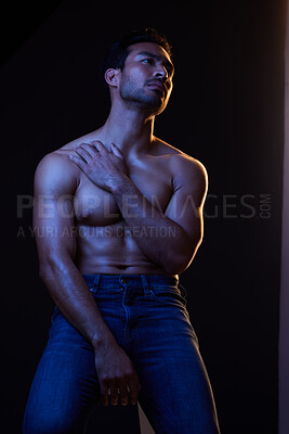 Buy stock photo Sexy, muscle and man with fitness, wellness and posing on a dark studio background. Person, guy and model with jeans, shirtless and atmosphere with training, power and body goals with aesthetic