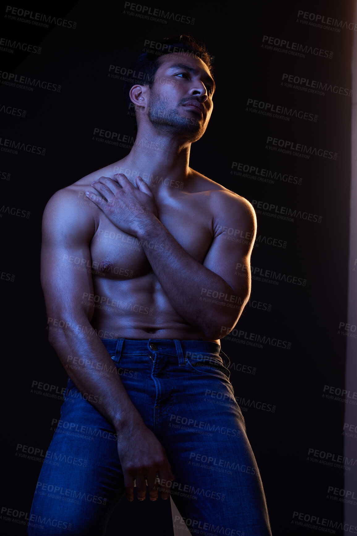 Buy stock photo Sexy, muscle and man with fitness, wellness and posing on a dark studio background. Person, guy and model with jeans, shirtless and atmosphere with training, power and body goals with aesthetic