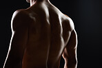 Man, back and muscle with silhouette, studio and shadow for wellness, health and strong by black background. Bodybuilder guy, shirtless and fitness with skin, aesthetic and power in dark for art