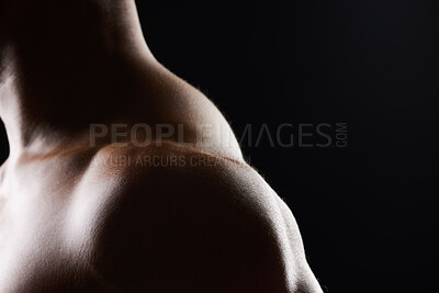 Buy stock photo Shoulder, closeup and strong muscle of man in studio isolated on black background mockup space. Body, fitness athlete and arm of model, bodybuilder power and workout for health, wellness and exercise