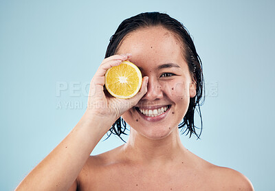 Buy stock photo Portrait, mockup or happy woman with orange for skincare or beauty in studio on blue background. Smile, dermatology shine or Asian person with natural fruits, vitamin c or face glow for wellness