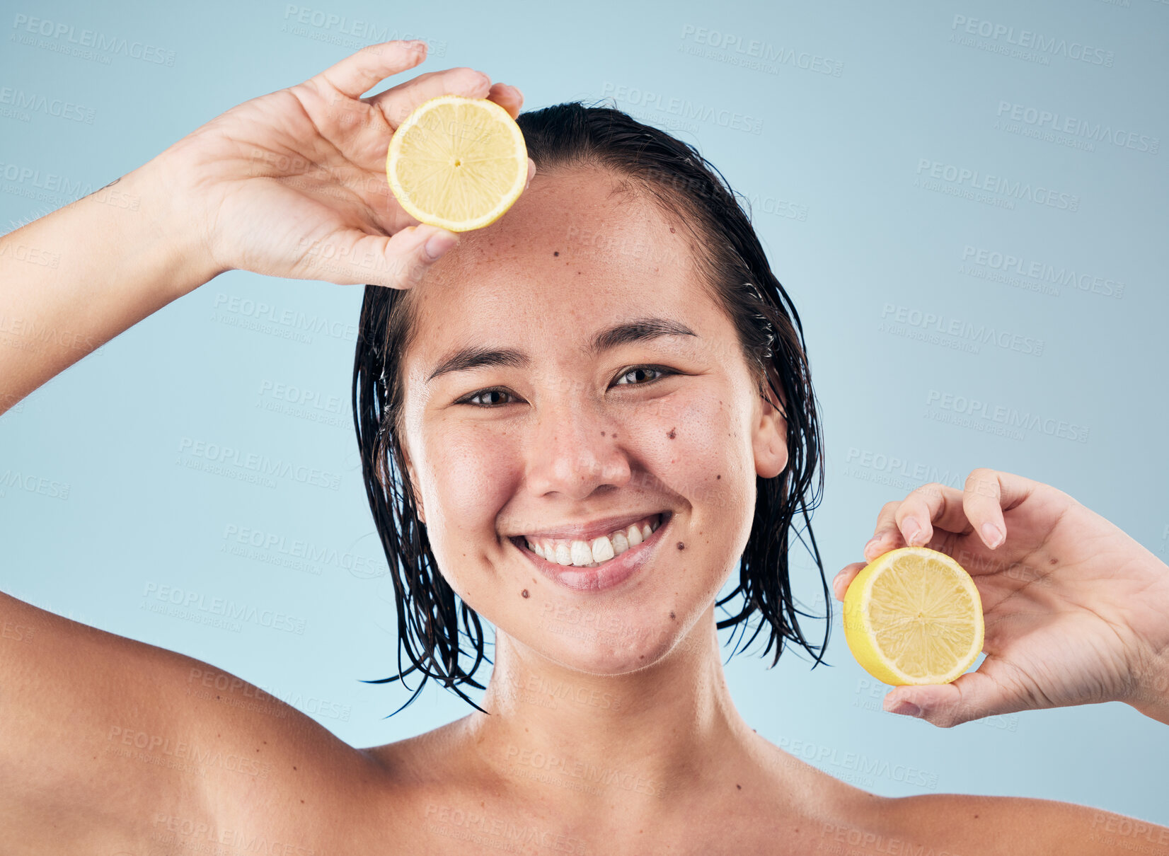 Buy stock photo Portrait, smile or happy woman with lemon for skincare or beauty in studio on blue background. Dermatology, shine or Asian person with natural fruits, vitamin c or face glow for wellness or health