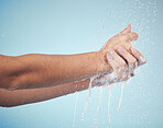 Hands, cleaning and woman with soap and water in studio, blue background and healthcare mockup or skincare. Model, closeup or washing skin for clean, hygiene and protection from bacteria or virus