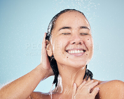 Buy stock photo Skincare, shower and happy woman washing hair in studio isolated on a blue background. Water splash, hygiene and model smile, cleaning and bathing for wellness, healthy skin beauty care in bathroom.