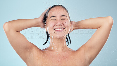 Buy stock photo Shower, water or happy woman cleaning hair or body for wellness in studio on blue background. Smile, beauty or wet female person washing or grooming for healthy natural hygiene or skincare to relax