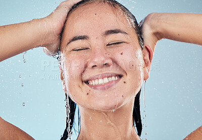 Buy stock photo Shower, face or happy woman cleaning hair for skincare or wellness in studio on blue background. Shampoo, beauty model or wet female person washing or grooming for healthy natural hygiene to relax