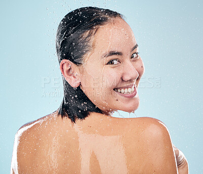 Buy stock photo Skincare, shower back and face of woman cleaning in studio isolated on a blue background. Water splash, hygiene and portrait of happy Asian model washing in bath for wellness, health and body beauty