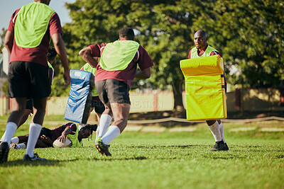 Buy stock photo Sports, team and men for rugby training, workout and exercise on grass field for competition. Fitness, collaboration and athletes with equipment tackle for practice, match and game for challenge