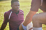 First aid, sport injury and black man with soccer accident, fitness and massage on a field. Training, workout and physical therapy of knee pain at game with healthcare emergency from exercise 