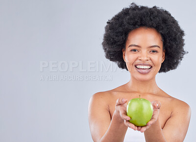 Buy stock photo Apple, black woman and portrait with health, diet and natural skincare glow in studio. Happy, face and fruit for healthy nutrition, grey background and mockup space with a smile from organic food